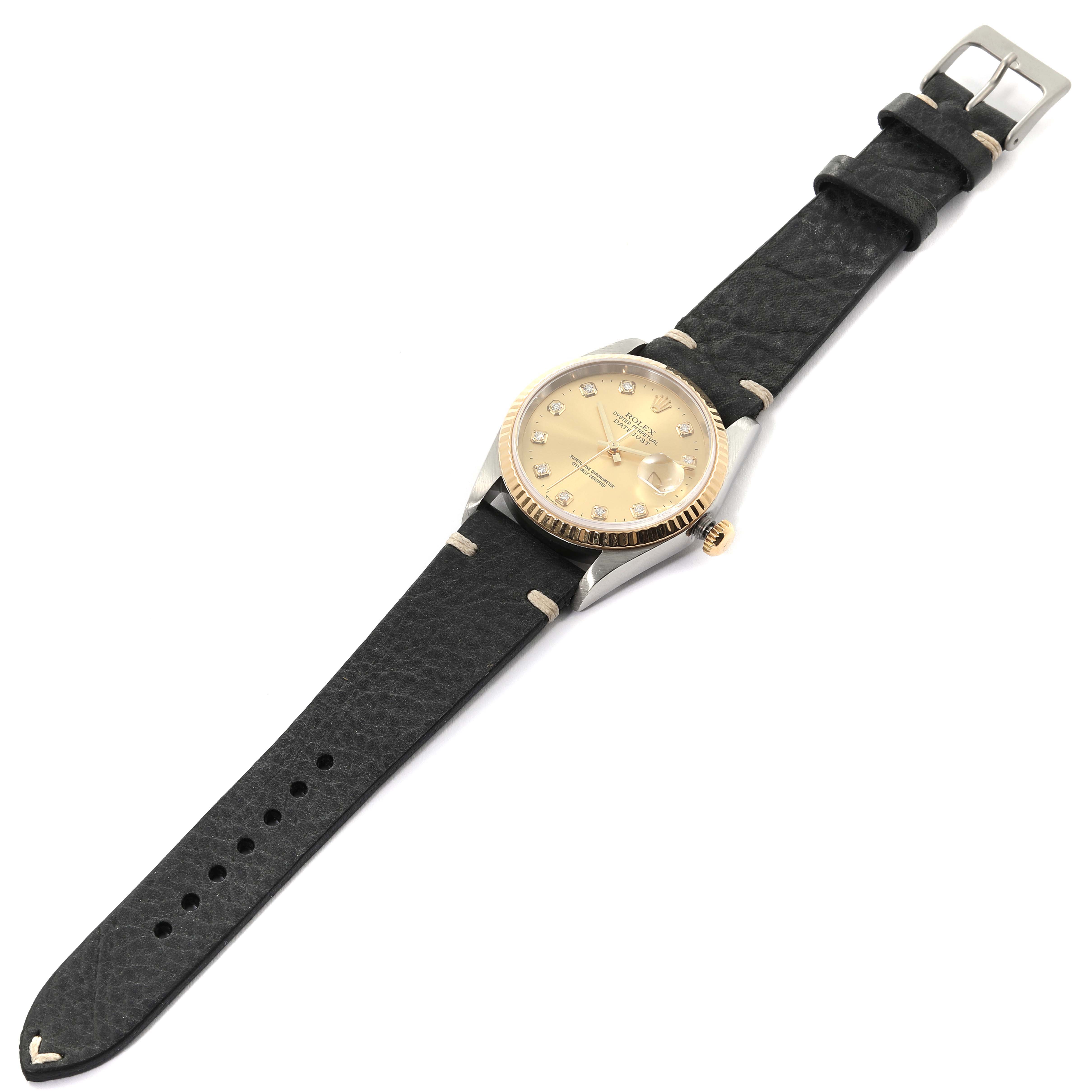 The image shows a Rolex Datejust 16233 Men's Steel and Gold (two tone) Champagne Dial 16233 Men's Steel and Gold (two tone) Champagne Dial watch with a gold dial, black leather strap, and visible buckle and crown.