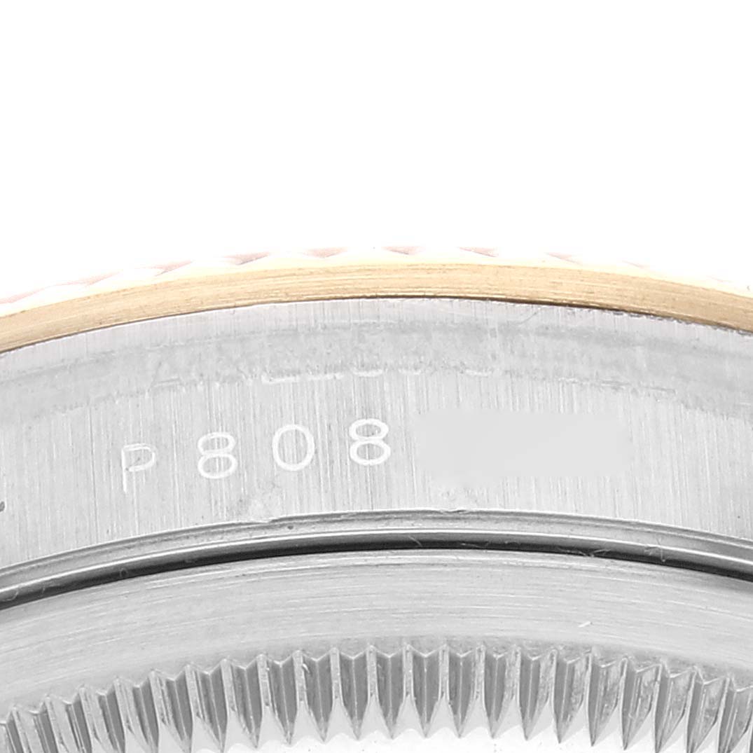 The image shows a close-up view of the engraved serial number on the side of the bezel of a Rolex Datejust 16233 Men's Steel and Gold (two tone) Champagne Dial 16233 Men's Steel and Gold (two tone) Champagne Dial watch.