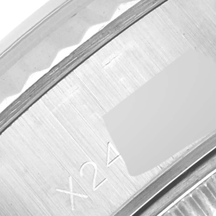 This image shows a close-up of the engraved bezel of a Rolex Datejust 69174 Women's Stainless Steel Silver Dial 69174 Women's Stainless Steel Silver Dial watch.