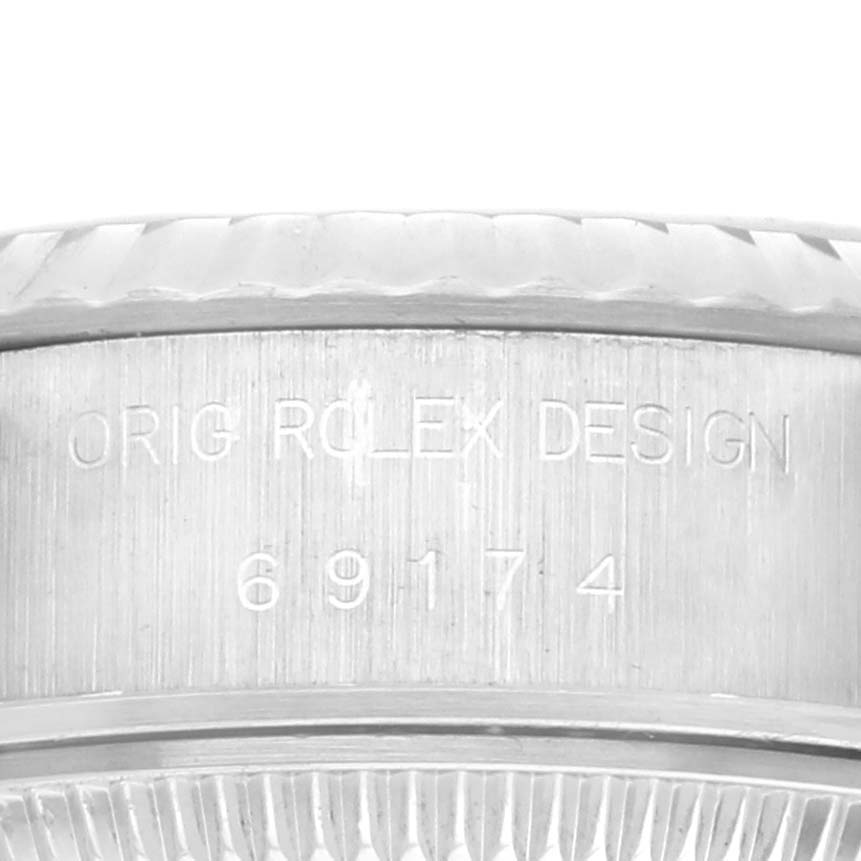 The image shows a close-up of the side casing of a Rolex Datejust 69174 Women's Stainless Steel Grey Dial 69174 Women's Stainless Steel Grey Dial, highlighting the model number engravings.