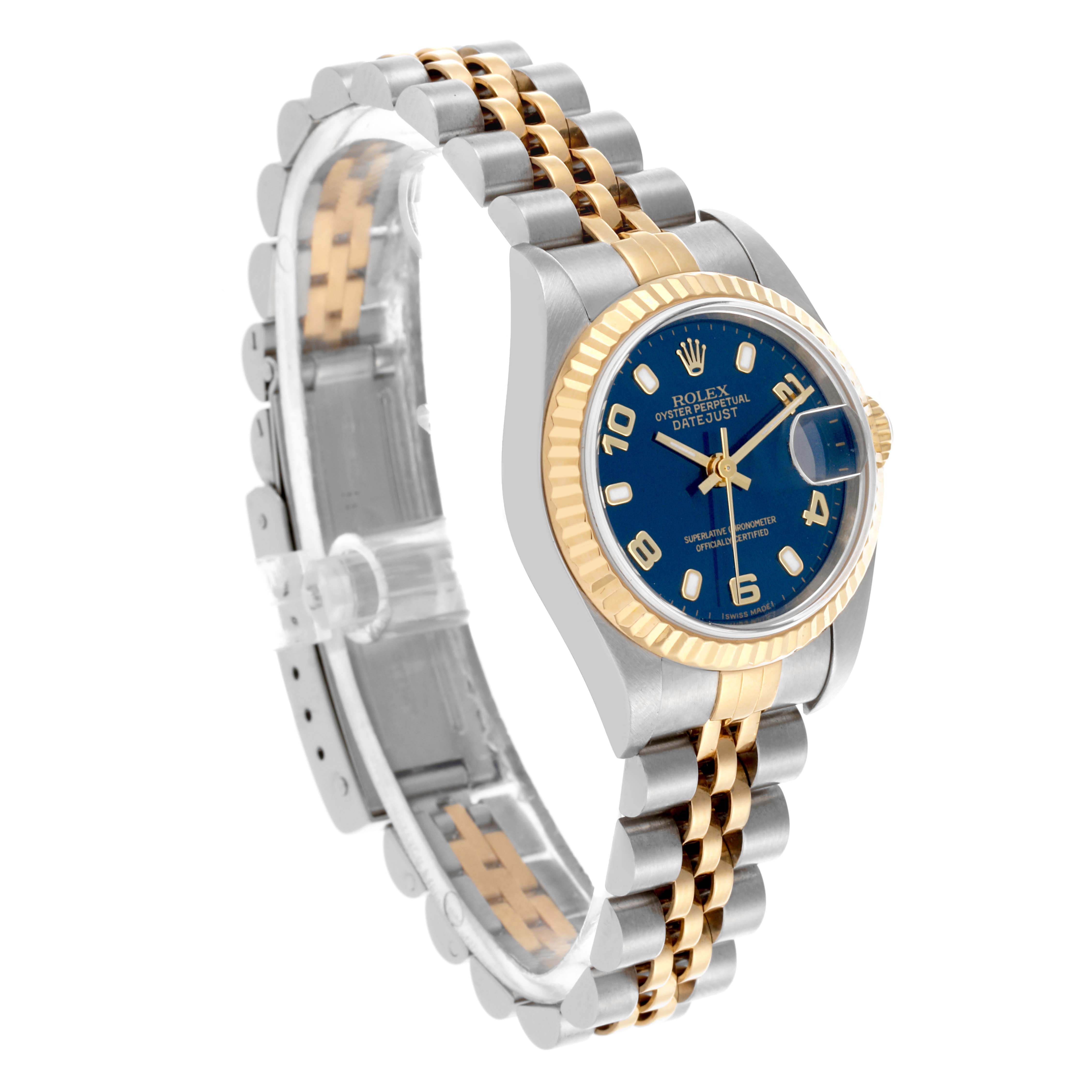 The Rolex Datejust 79173 Women's Steel and Gold (two tone) Blue Dial 79173 Women's Steel and Gold (two tone) Blue Dial watch is shown at a three-quarter angle, highlighting its face, fluted bezel, and two-tone bracelet.