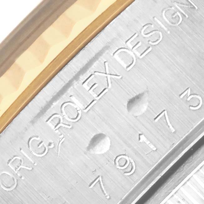 The image shows a close-up of the serial engraving on the side of the Rolex Datejust 79173 Women's Steel and Gold (two tone) Blue Dial 79173 Women's Steel and Gold (two tone) Blue Dial case.