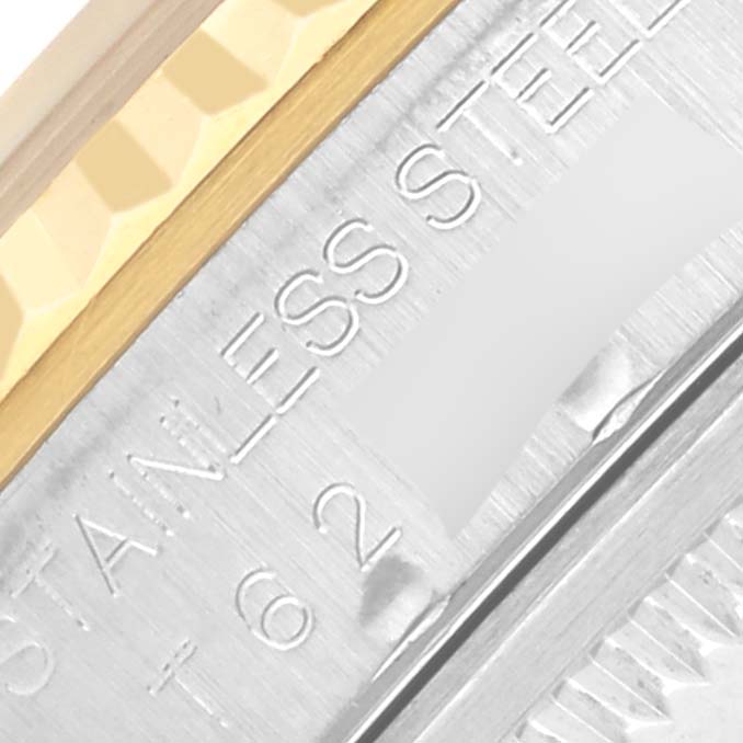 The image shows a close-up of the Rolex Datejust 16233 Men's Steel and Gold (two tone) Beige Dial 16233 Men's Steel and Gold (two tone) Beige Dial, highlighting the edge of the bezel and engraved text on the case.