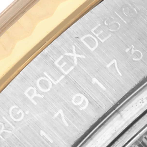 The image shows a close-up of the case side engraving on a Rolex Datejust 179173 Women's Steel and Gold (two tone) Mother of Pearl Dial 179173 Women's Steel and Gold (two tone) Mother of Pearl Dial, featuring part of the bezel and case.