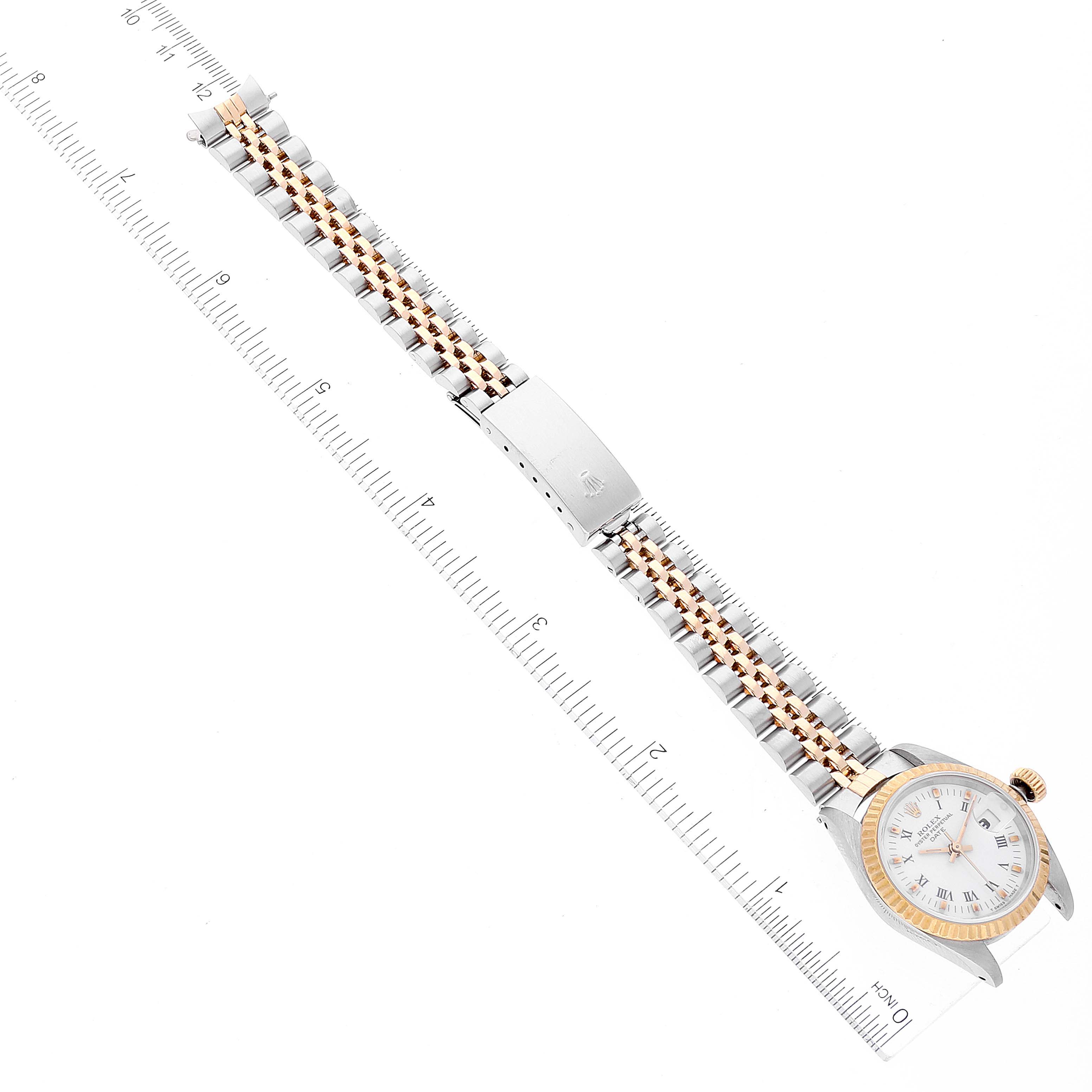 The Rolex Datejust 69173 Women's Steel and Gold (two tone) White Dial 69173 Women's Steel and Gold (two tone) White Dial watch is displayed flat, showcasing the entire bracelet, clasp, and watch face with a ruler for size reference.