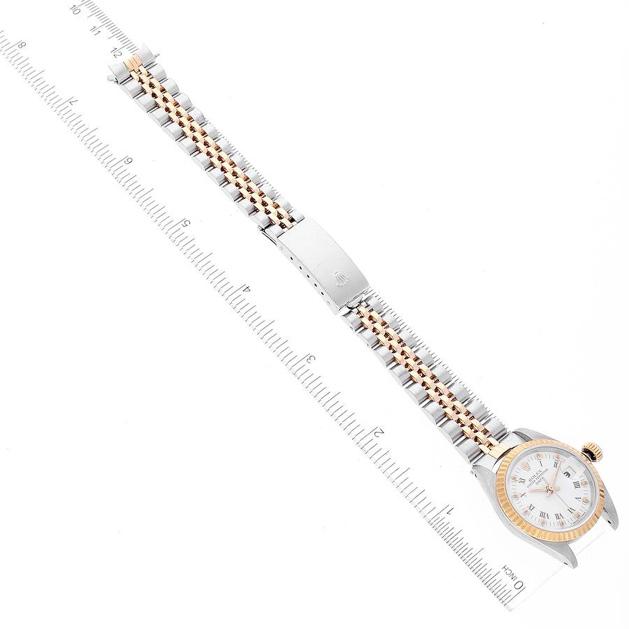 The Rolex Datejust 69173 Women's Steel and Gold (two tone) White Dial 69173 Women's Steel and Gold (two tone) White Dial watch is displayed flat, showcasing the entire bracelet, clasp, and watch face with a ruler for size reference.