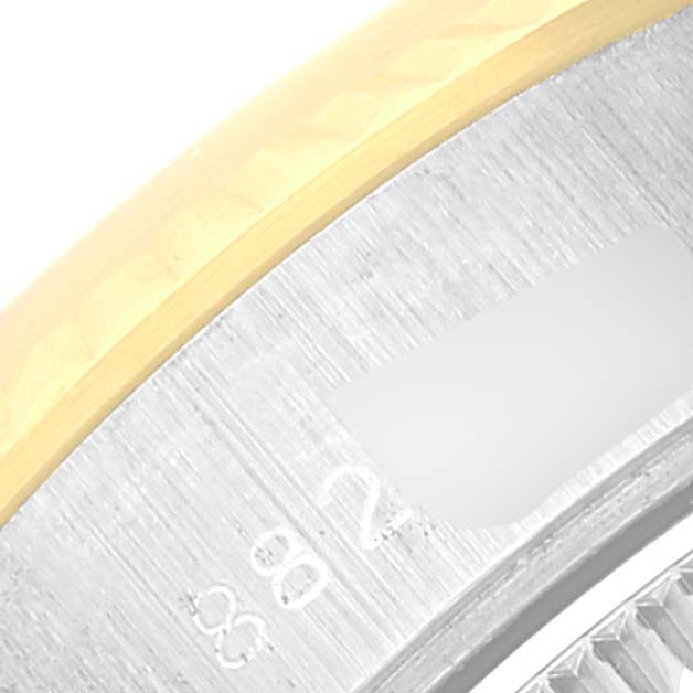 The image shows a close-up of the bezel and part of the caseback of a Rolex Datejust 69173 Women's Steel and Gold (two tone) White Dial 69173 Women's Steel and Gold (two tone) White Dial watch.