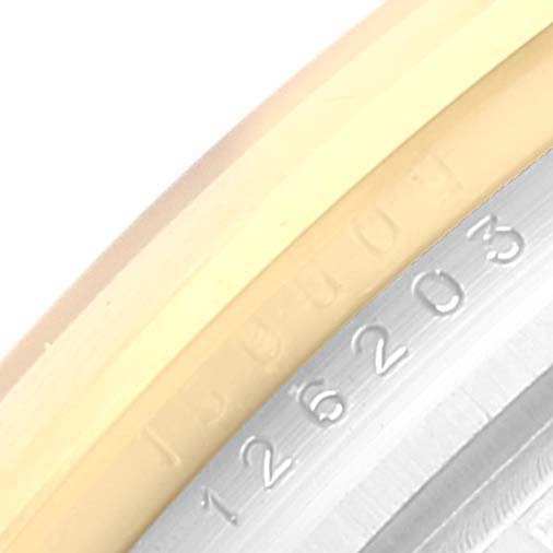 This image shows a close-up of the serial number engraved on the case edge of a Rolex Datejust 126203 Men's Steel and Gold (two tone) White Dial 126203 Men's Steel and Gold (two tone) White Dial model.