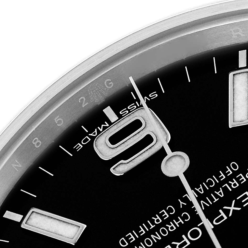 The image shows a close-up of the Rolex Explorer 214270 Men's Stainless Steel Black Dial 214270 Men's Stainless Steel Black Dial watch dial, focusing on the 9 o'clock numeral and hour markers.