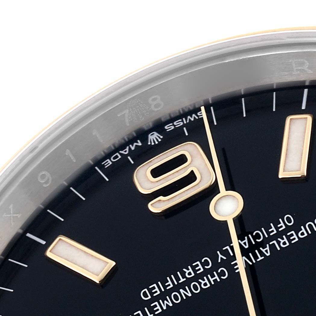 The image shows a close-up angle of the dial, hands, and markers of a Rolex Explorer 124273 Men's Steel and Gold (two tone) Black Dial 124273 Men's Steel and Gold (two tone) Black Dial watch, highlighting the "9" and "Swiss Made" text.