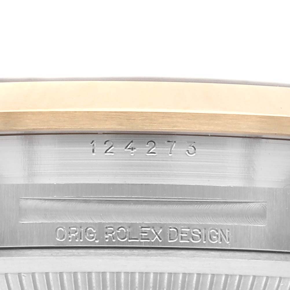 This image shows a close-up of the case side engraving on a Rolex Explorer 124273 Men's Steel and Gold (two tone) Black Dial 124273 Men's Steel and Gold (two tone) Black Dial, highlighting the model number and "Orig. Rolex Design."