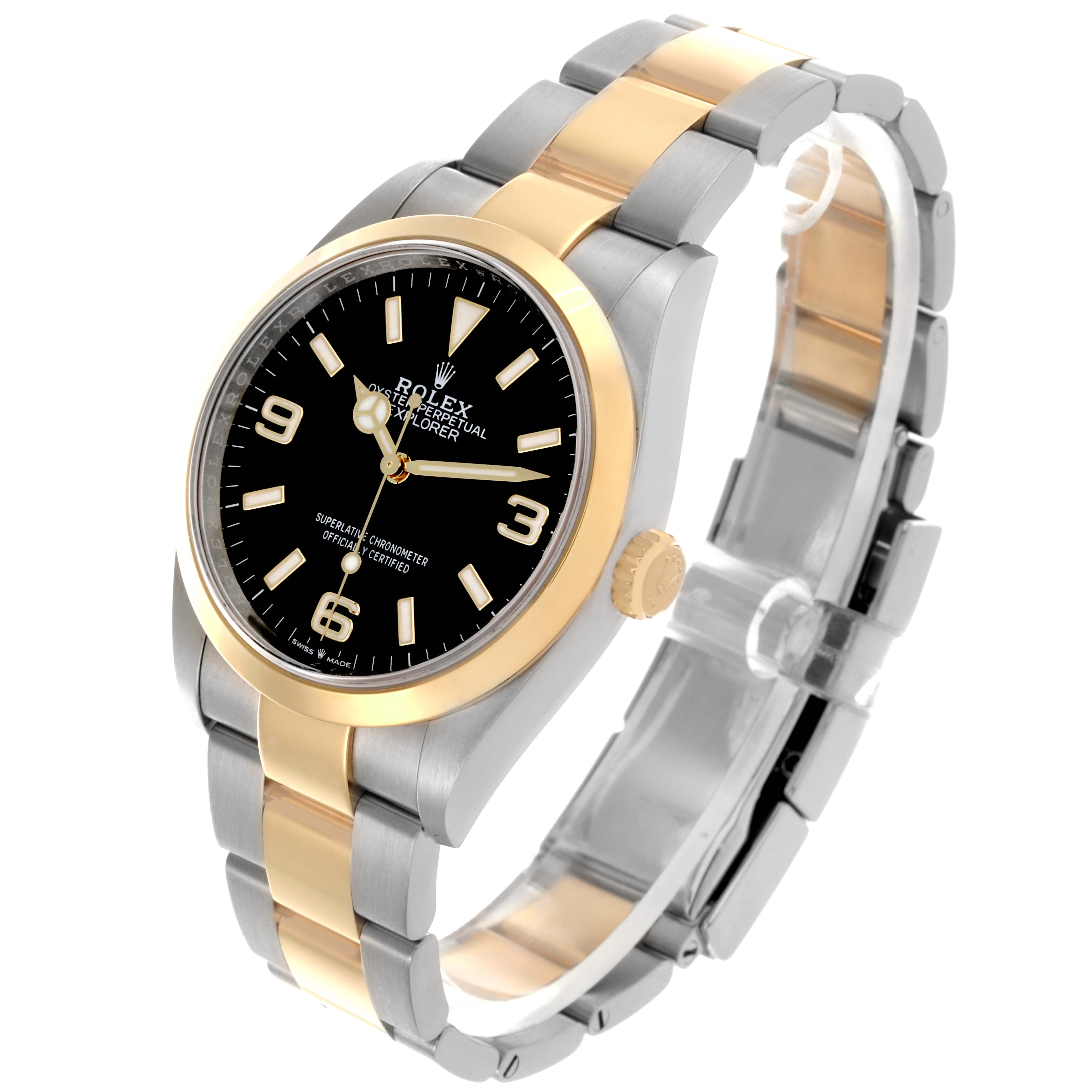 The Rolex Explorer 124273 Men's Steel and Gold (two tone) Black Dial 124273 Men's Steel and Gold (two tone) Black Dial watch is shown at a three-quarter angle, displaying the face, bezel, bracelet, and crown.