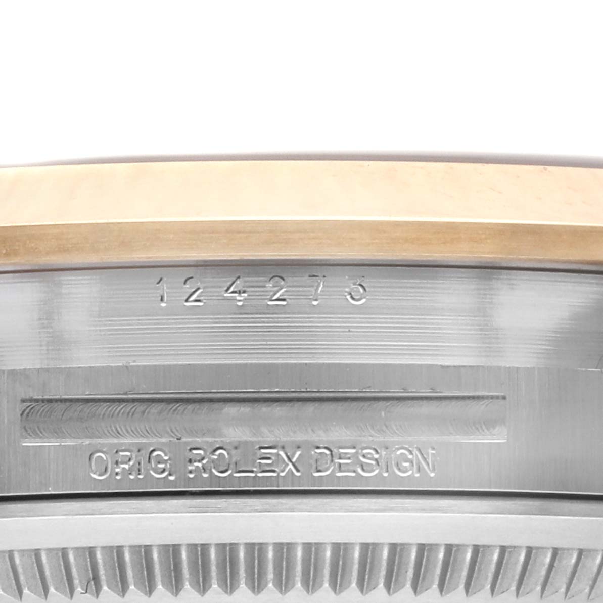 The image shows a close-up of the side of a Rolex Explorer 124273 Men's Steel and Gold (two tone) Black Dial 124273 Men's Steel and Gold (two tone) Black Dial watch with visible model number and "Orig. Rolex Design" engraving.