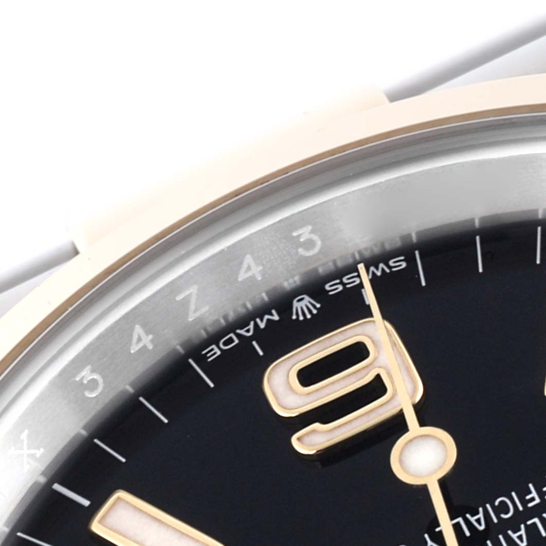 The image shows a close-up of the dial and bezel of a Rolex Explorer 124273 Men's Steel and Gold (two tone) Black Dial 124273 Men's Steel and Gold (two tone) Black Dial watch at an angle, highlighting the numeral "9" and "Swiss Made" text.