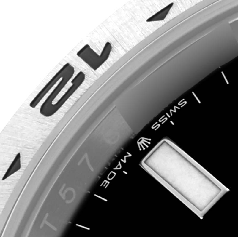 The image shows a close-up angle of the bezel and part of the dial of a Rolex Explorer M226570-0002 Men's Stainless Steel Black Dial M226570-0002 Men's Stainless Steel Black Dial watch, featuring numerals and the "Swiss Made" text.