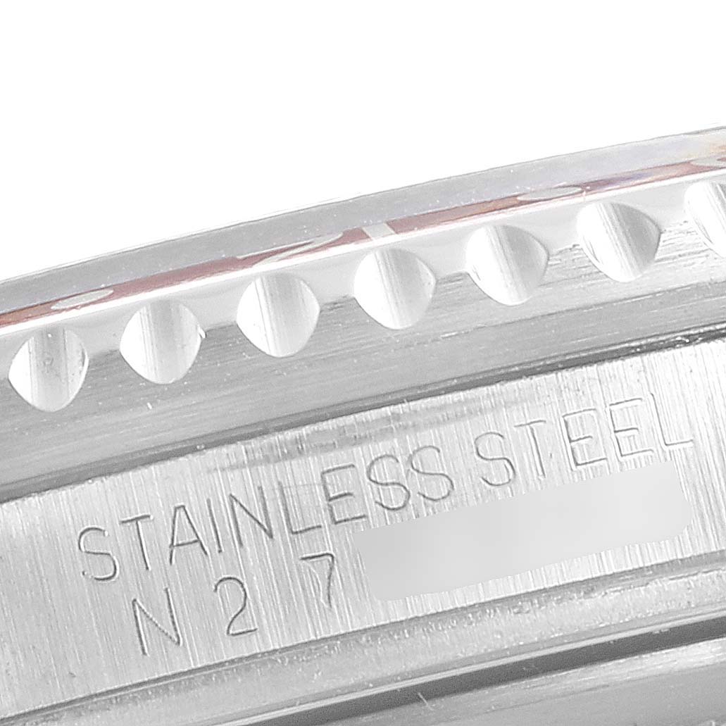 This image shows a close-up of the stainless steel bezel and engraved serial number on a Rolex GMT-Master 16710 Men's Stainless Steel Black Dial 16710 Men's Stainless Steel Black Dial watch.