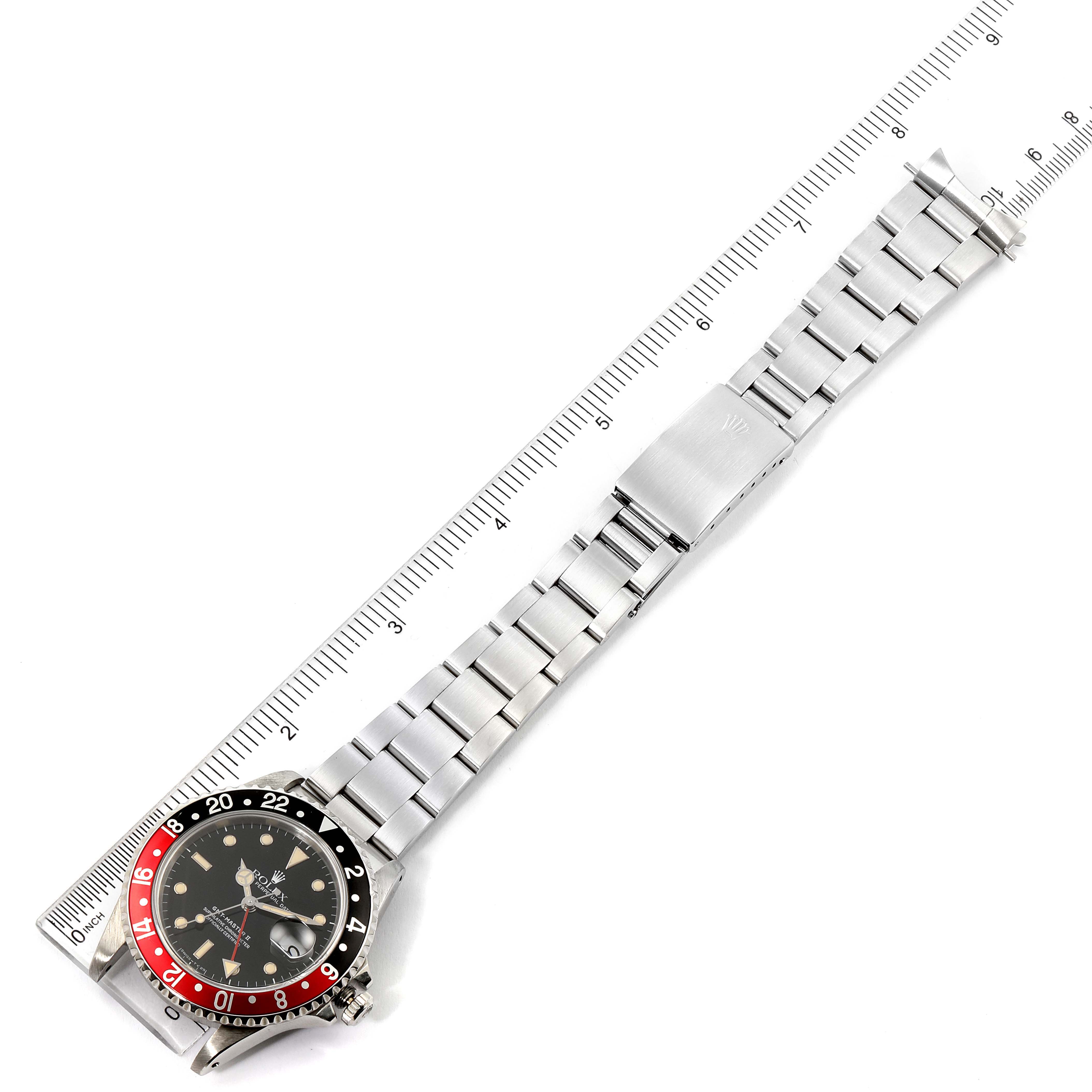 The image shows a Rolex GMT-Master 16710 Men's Stainless Steel Black Dial 16710 Men's Stainless Steel Black Dial watch laid flat with a ruler, displaying the full watch and bracelet.