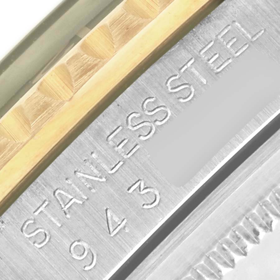 The image shows a close-up of the side of the Rolex GMT-Master 16753 Men's Steel and Gold (two tone) Black Dial 16753 Men's Steel and Gold (two tone) Black Dial watch, highlighting the stainless steel and gold detailing with engravings.