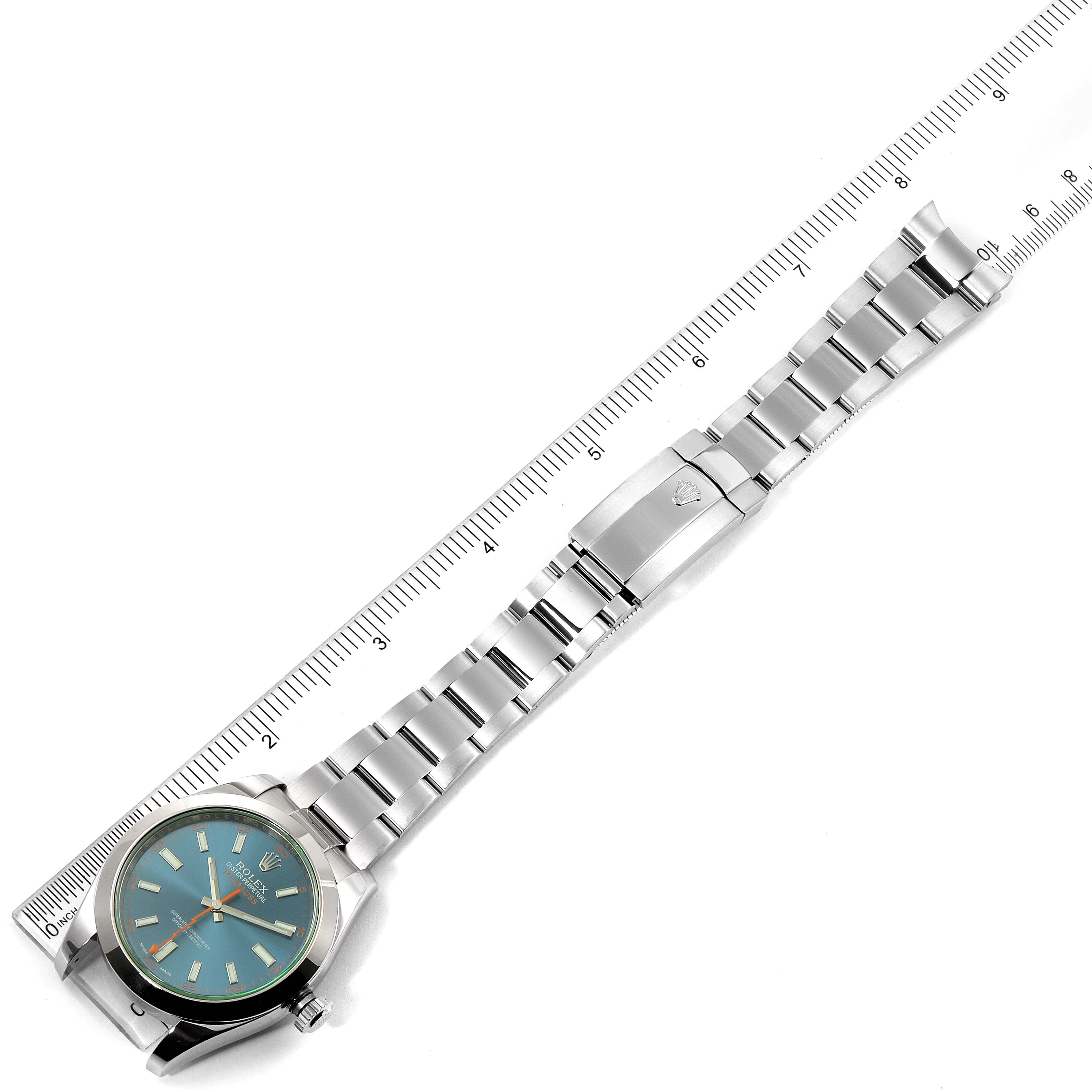 The Rolex Milgauss 116400GV Men's Stainless Steel Blue Dial 116400GV Men's Stainless Steel Blue Dial watch is shown from a top-down angle, displaying its face, bracelet, and clasp alongside a ruler.
