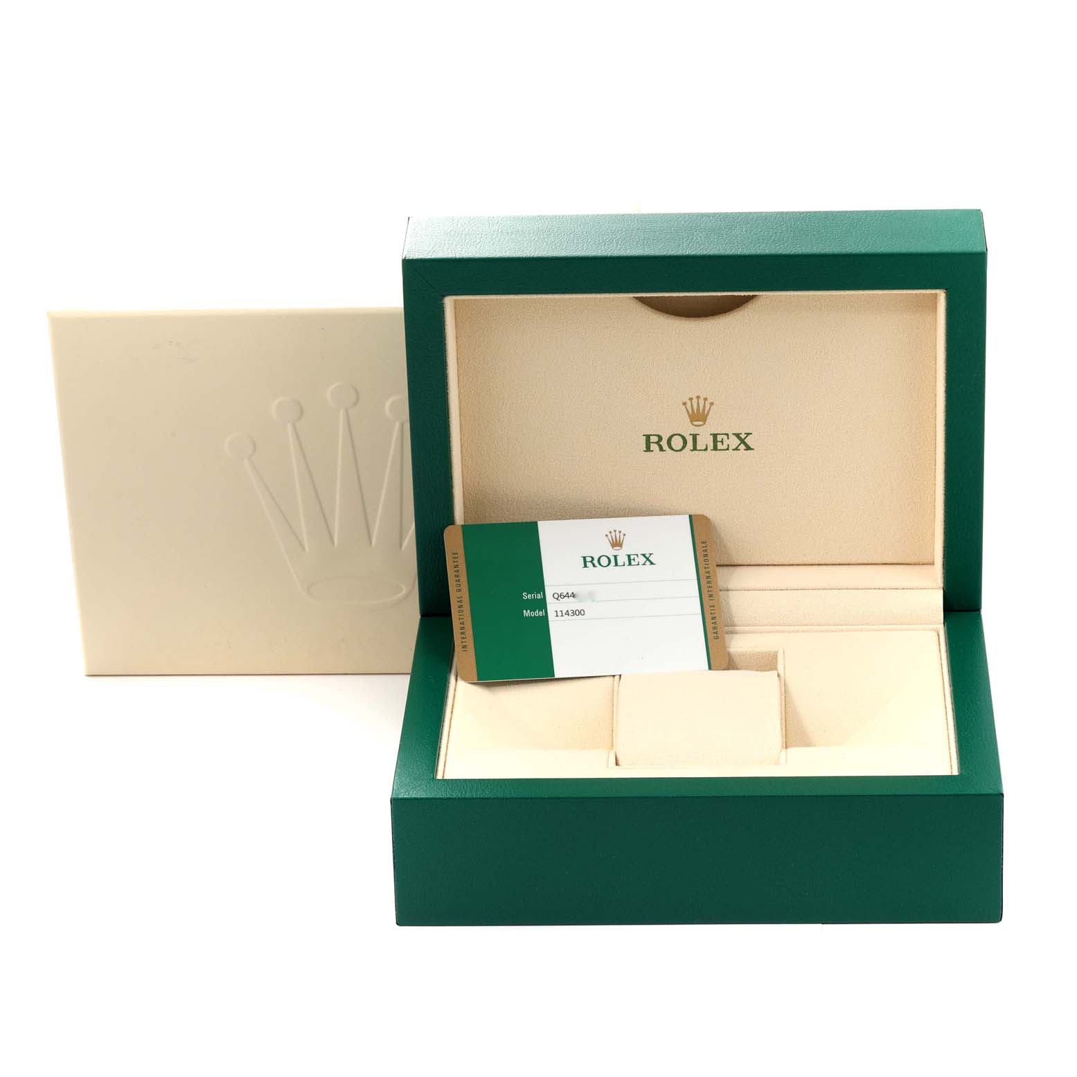 The image shows the open packaging of a Rolex Oyster Perpetual 114300 Men's Stainless Steel Grey Dial 114300 Men's Stainless Steel Grey Dial watch, including the box and warranty card.