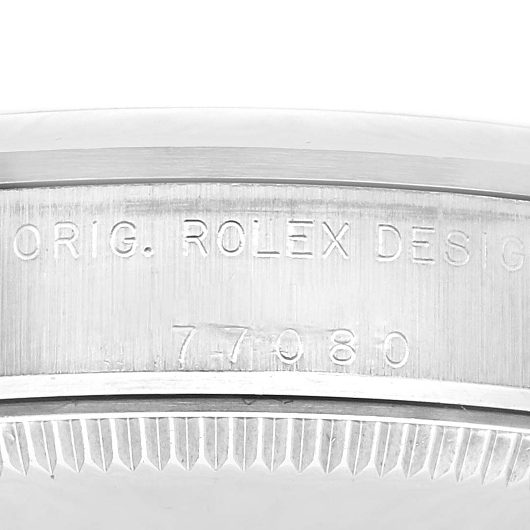 The image shows a close-up of the bezel and engraved case side of a Mid-Size Rolex watch, displaying "ORIG. ROLEX DESIGN" and model number "77080."
