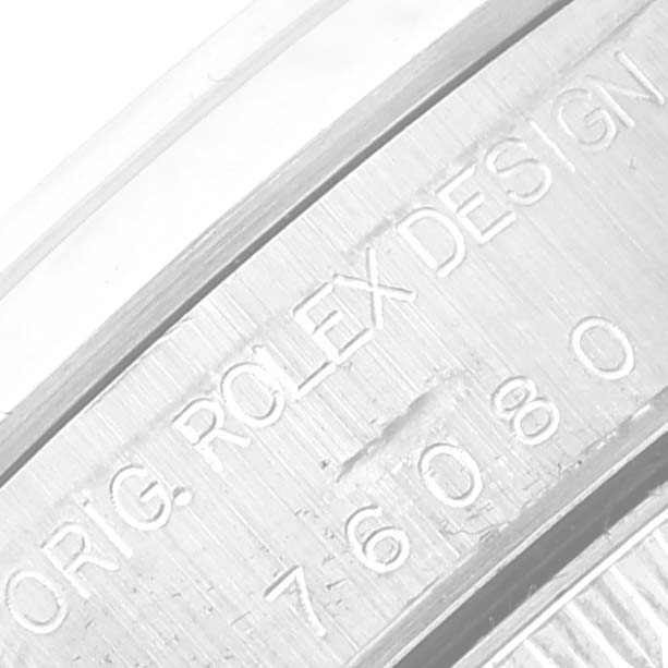 This image shows a close-up of the engraved inner bezel of a Rolex Oyster Perpetual 76080 Women's Stainless Steel Silver Dial 76080 Women's Stainless Steel Silver Dial watch.