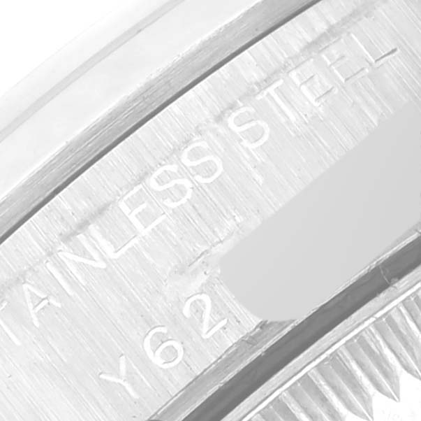 This image shows a close-up view of the engraving on the Oyster Perpetual Rolex watch, highlighting the text "STAINLESS STEEL."