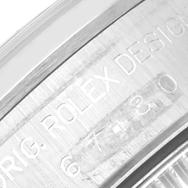 This is a close-up of the engraved case back of a Rolex Oyster Perpetual 67180 Women's Stainless Steel Black Dial 67180 Women's Stainless Steel Black Dial watch.