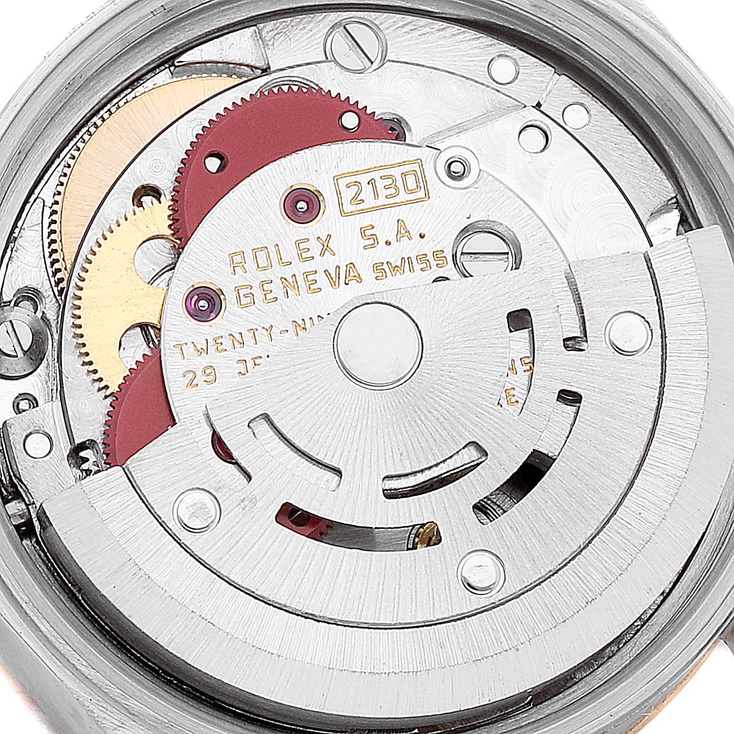 This image shows the inner mechanism of the Rolex Oyster Perpetual 67193 Women's Steel and Gold (two tone) Champagne Dial 67193 Women's Steel and Gold (two tone) Champagne Dial watch, displaying gears, the rotor, and engraving details.