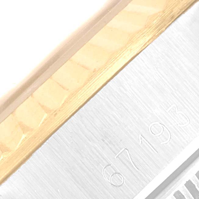 The image depicts a close-up of the serial number and part of the bezel of a Rolex Oyster Perpetual 67193 Women's Steel and Gold (two tone) Champagne Dial 67193 Women's Steel and Gold (two tone) Champagne Dial watch.