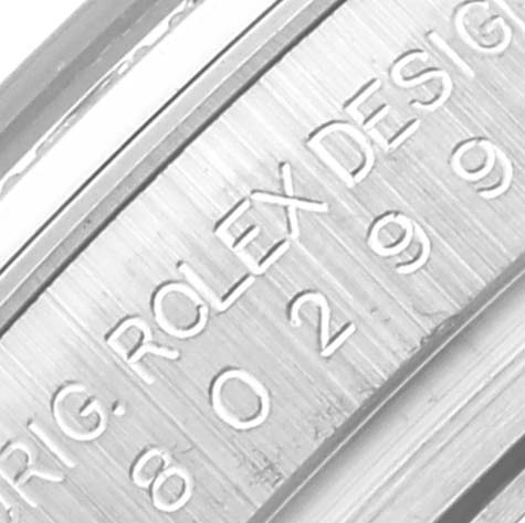 The image shows the engraved side of the casing of a Rolex Pearlmaster 80299 Women
s White Gold Mother of Pearl Dial 80299 Women
s White Gold Mother of Pearl Dial watch at a close-up angle.