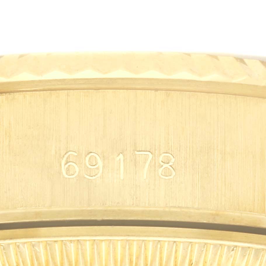 The image shows a close-up of the Rolex President 69178 Women's Yellow Gold Champagne Dial 69178 Women's Yellow Gold Champagne Dial model's case edge with the model number 69178 engraved.
