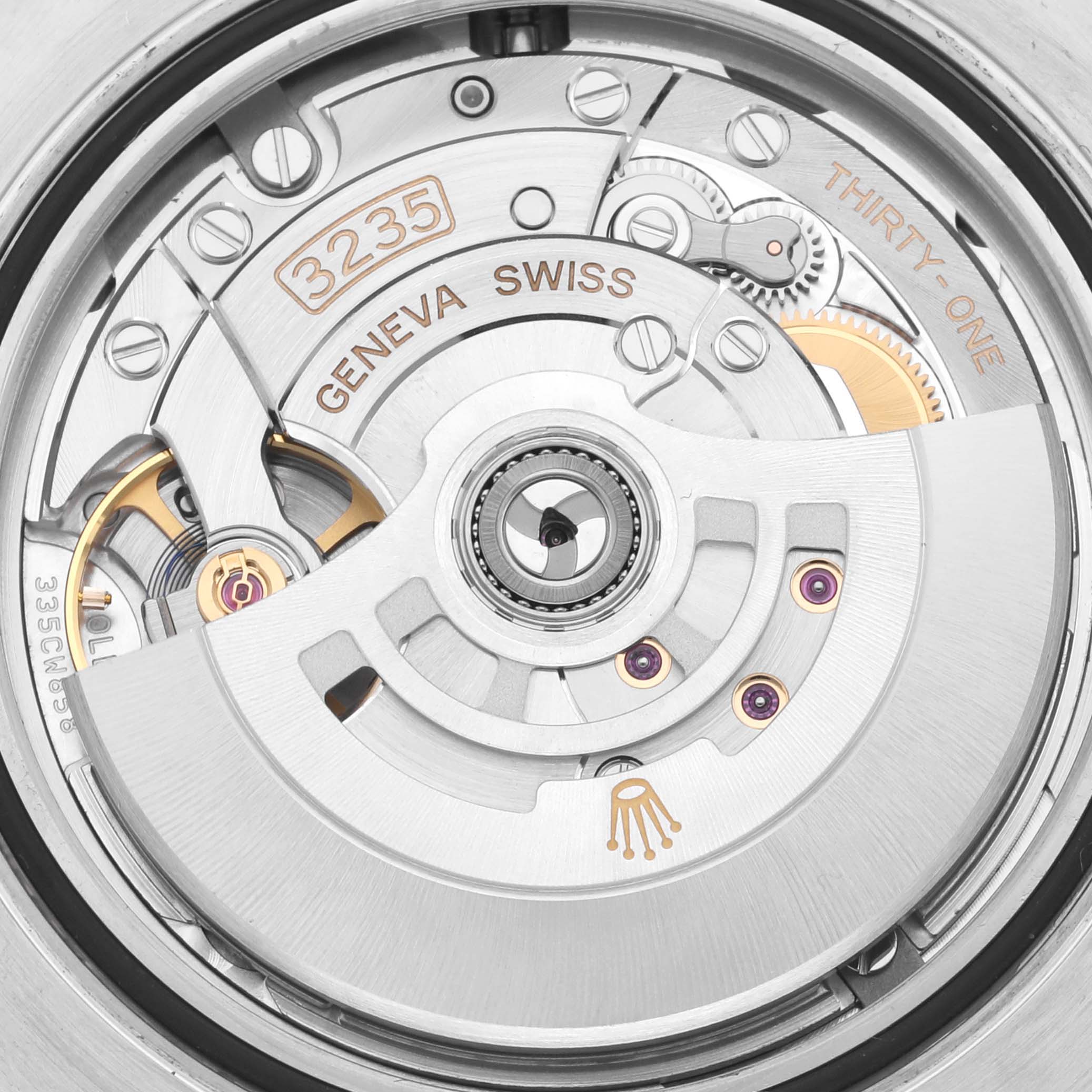 The image shows a close-up of the Rolex Submariner 126613LB Men's Steel and Gold (two tone) Blue Dial 126613LB Men's Steel and Gold (two tone) Blue Dial's movement, highlighting the intricate mechanical parts.