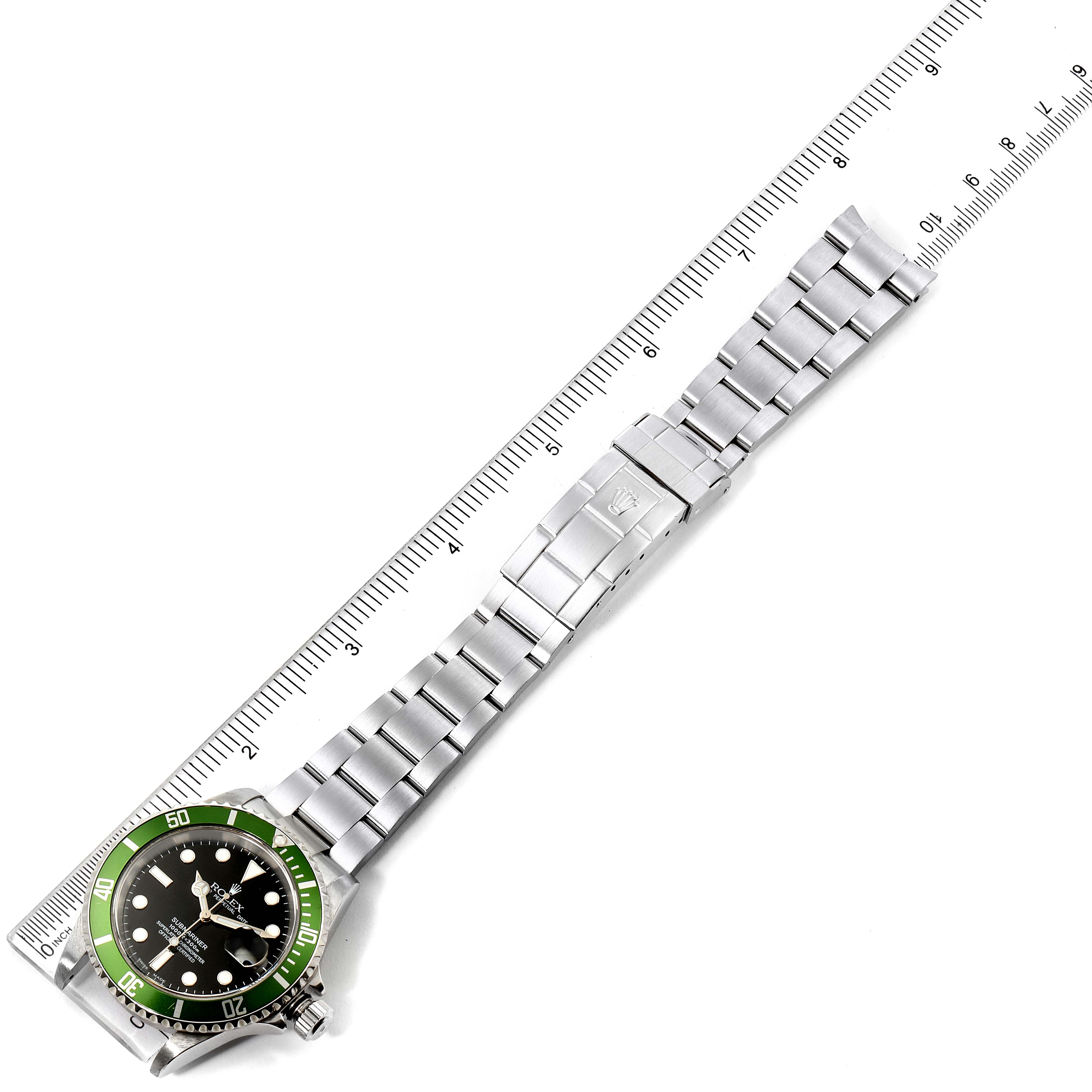 The image shows a Rolex Submariner 16610LV Men's Stainless Steel Black Dial 16610LV Men's Stainless Steel Black Dial watch, displaying its face, bezel, and bracelet, laid flat next to a ruler for measurement.