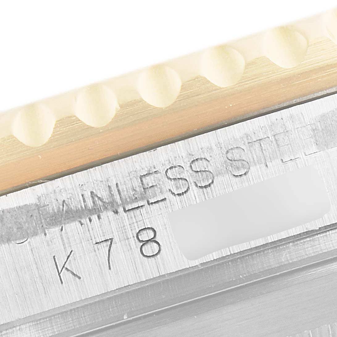 The image shows a close-up of the serial number engraving and a portion of the bezel on a Rolex Submariner 16613 Men's Steel and Gold (two tone) Blue Dial 16613 Men's Steel and Gold (two tone) Blue Dial watch.