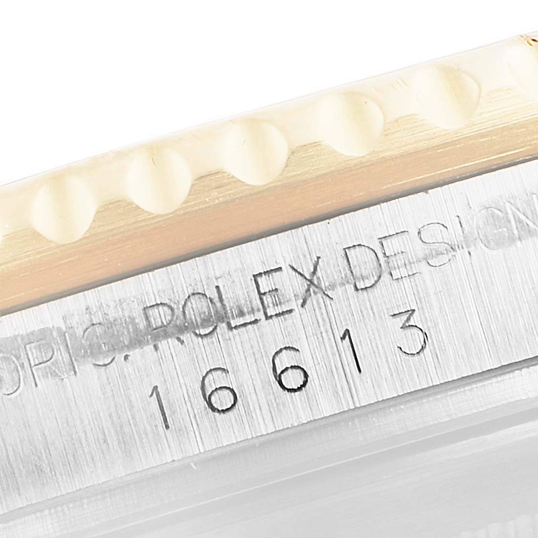 This image shows a close-up of the case side on a Rolex Submariner 16613 Men's Steel and Gold (two tone) Blue Dial 16613 Men's Steel and Gold (two tone) Blue Dial watch, highlighting the model number 16613 engraved on it.