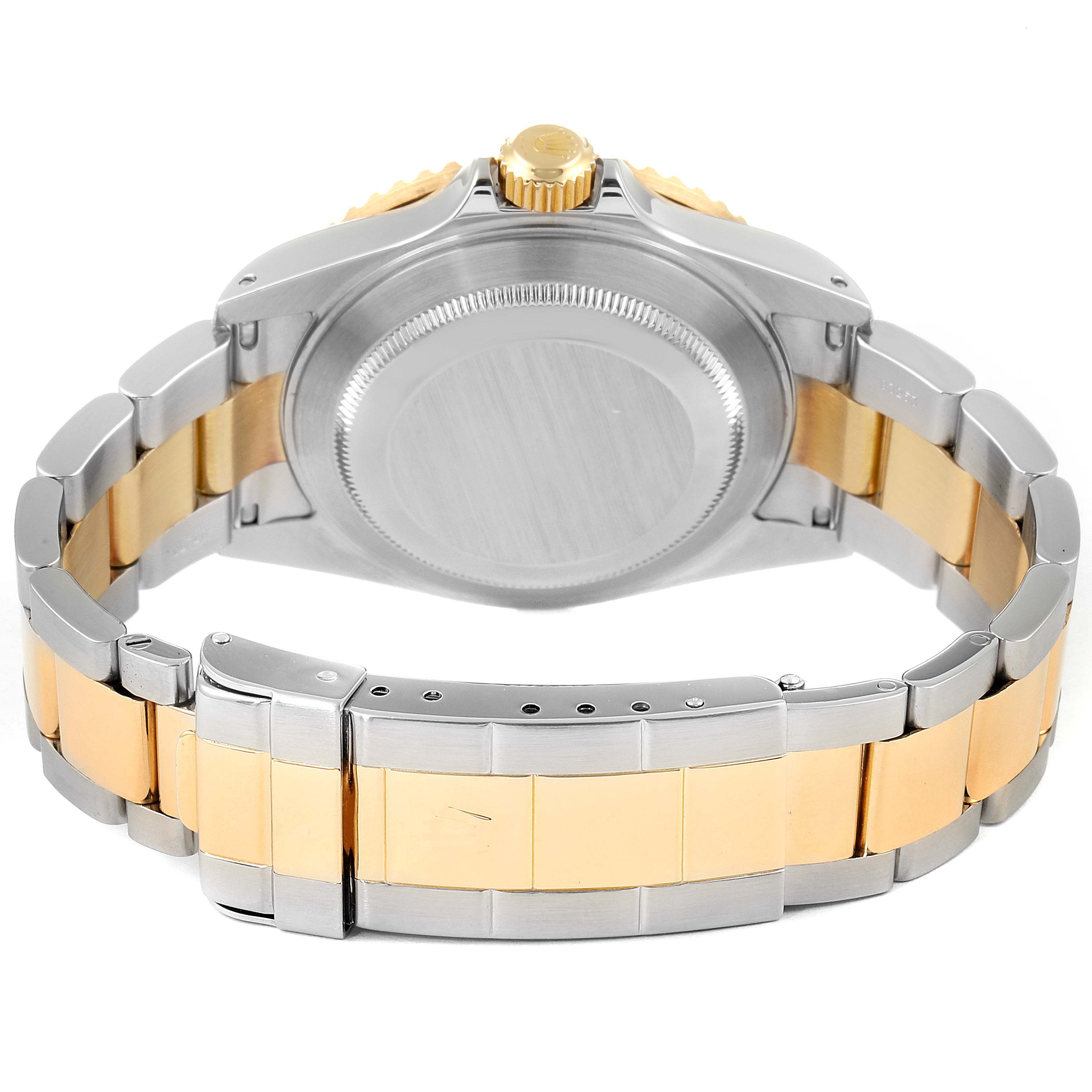 The image shows the back view of a Rolex Submariner 16613 Men's Steel and Gold (two tone) Blue Dial 16613 Men's Steel and Gold (two tone) Blue Dial watch with a two-tone metal bracelet and closed case back.