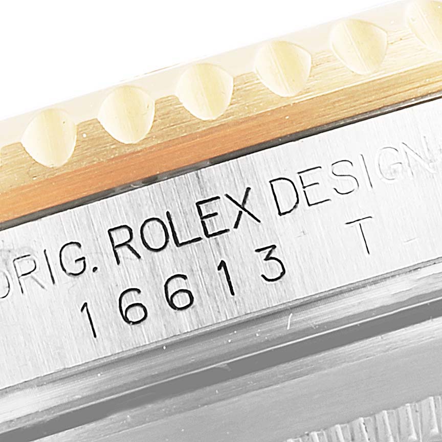 This image displays the side view of a Rolex Submariner 16613 Men's Steel and Gold (two tone) Blue Dial 16613 Men's Steel and Gold (two tone) Blue Dial, showing the engravings on the case near the bezel.