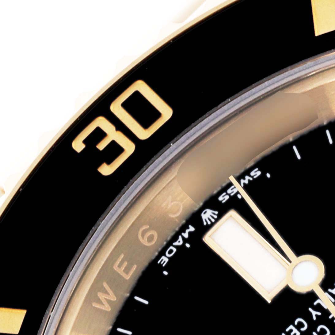 The image shows a close-up of the bezel and partially the dial of a Rolex Submariner 126618LN Men
s Yellow Gold Black Dial 126618LN Men
s Yellow Gold Black Dial watch, highlighting the "30" marker.