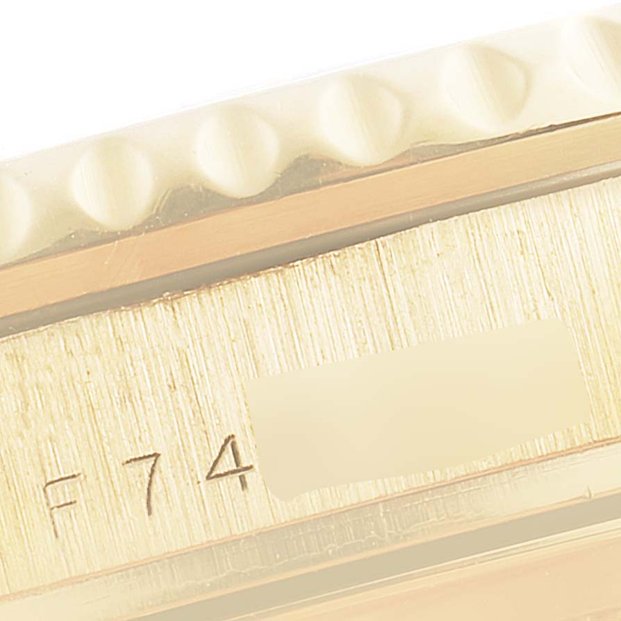 The image shows a close-up of the bezel and case side with a serial number of a Rolex Submariner 16618 Men's Yellow Gold Blue Dial 16618 Men's Yellow Gold Blue Dial watch.