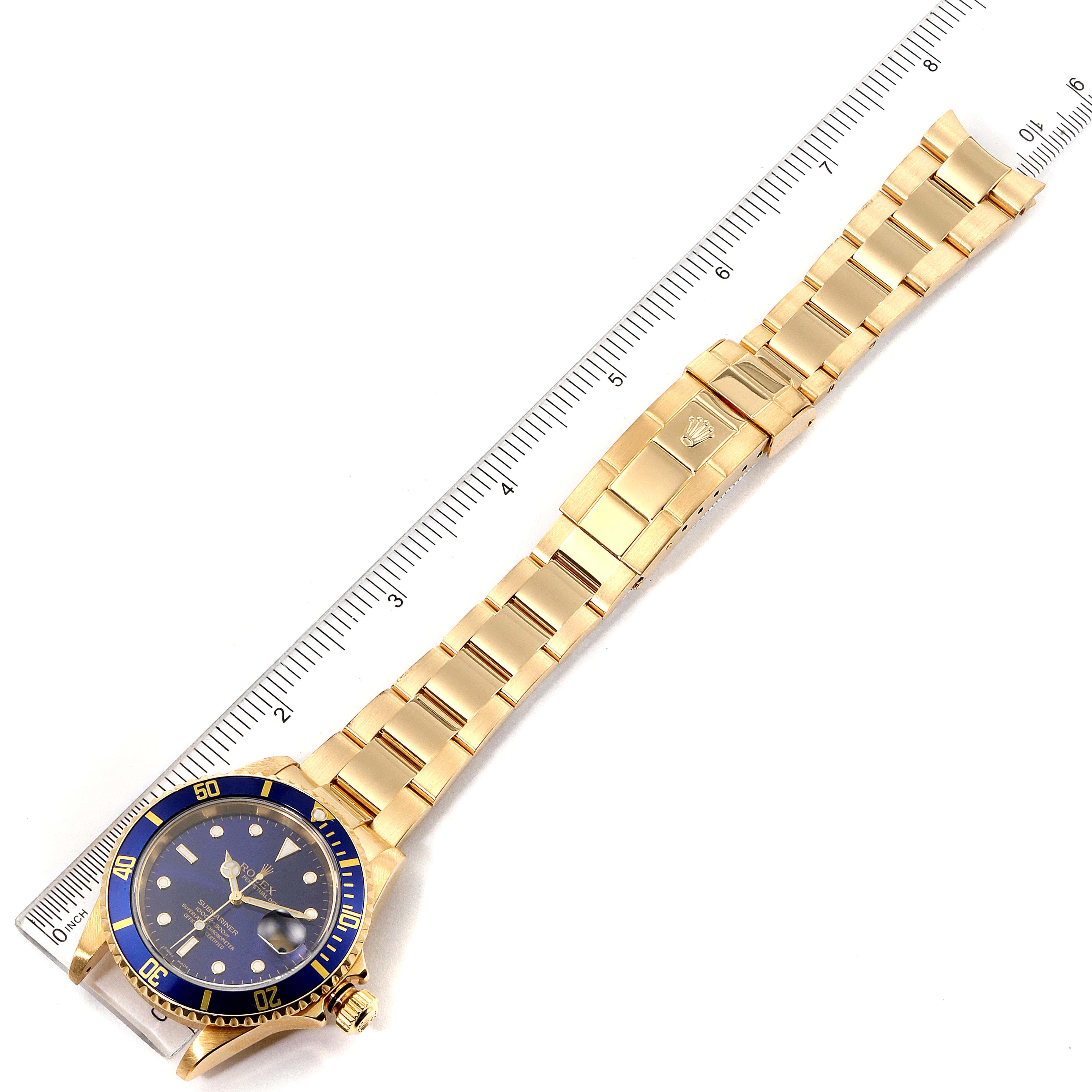 The image shows a top-down view of the Rolex Submariner 16618 Men's Yellow Gold Blue Dial 16618 Men's Yellow Gold Blue Dial watch, featuring the full watch with a blue dial and gold bracelet.