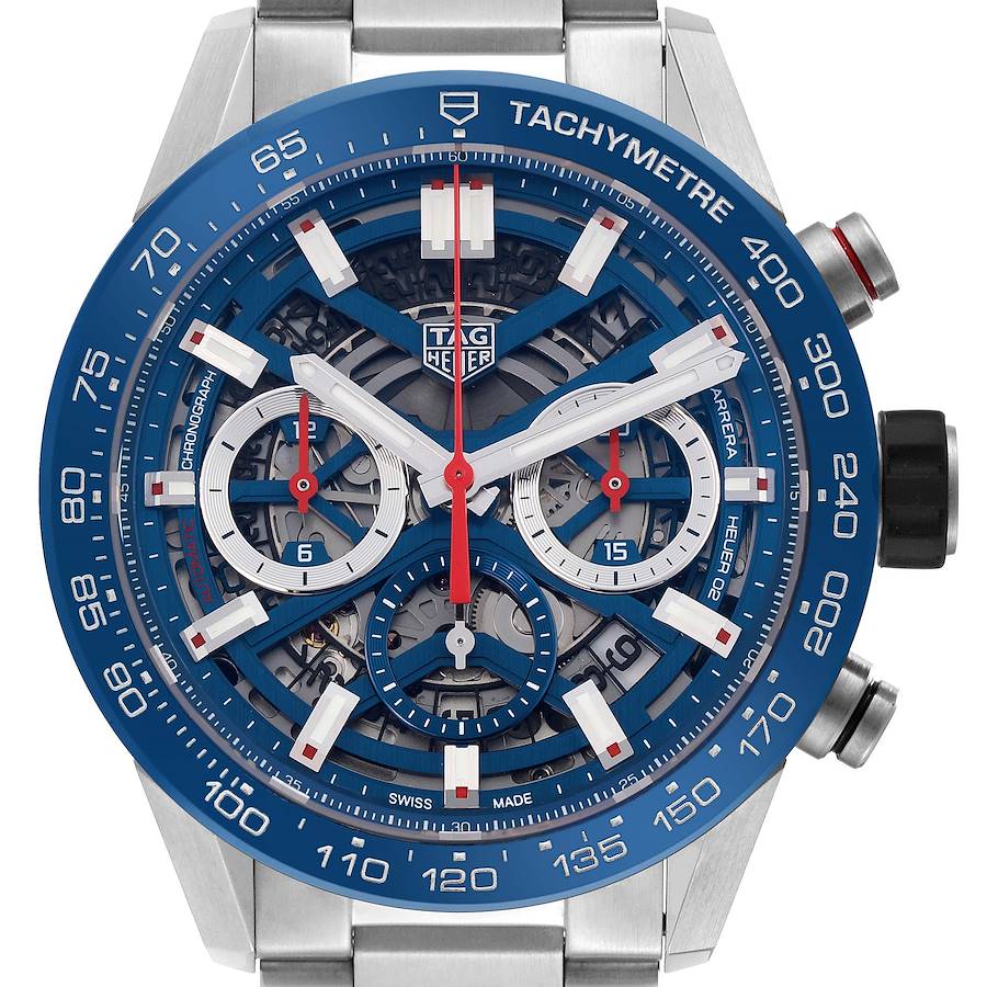 The Tag Heuer Carrera watch is shown from the front, highlighting its blue tachymeter bezel and chronograph sub-dials.