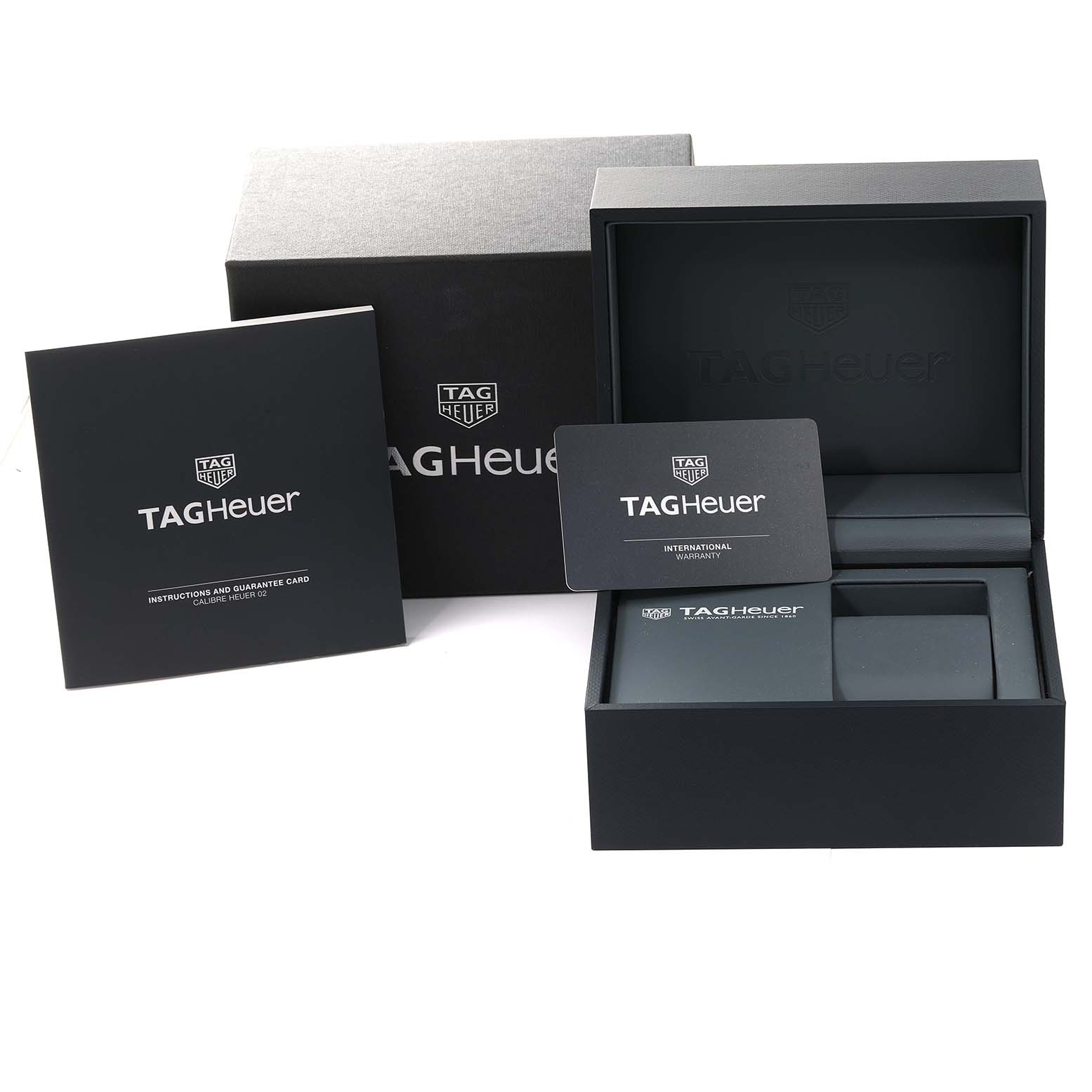 This image shows the packaging, instruction manual, and warranty card for the Tag Heuer Carrera CBN2A1A.BA0643 Men's Stainless Steel Blue Dial CBN2A1A.BA0643 Men's Stainless Steel Blue Dial model watch.