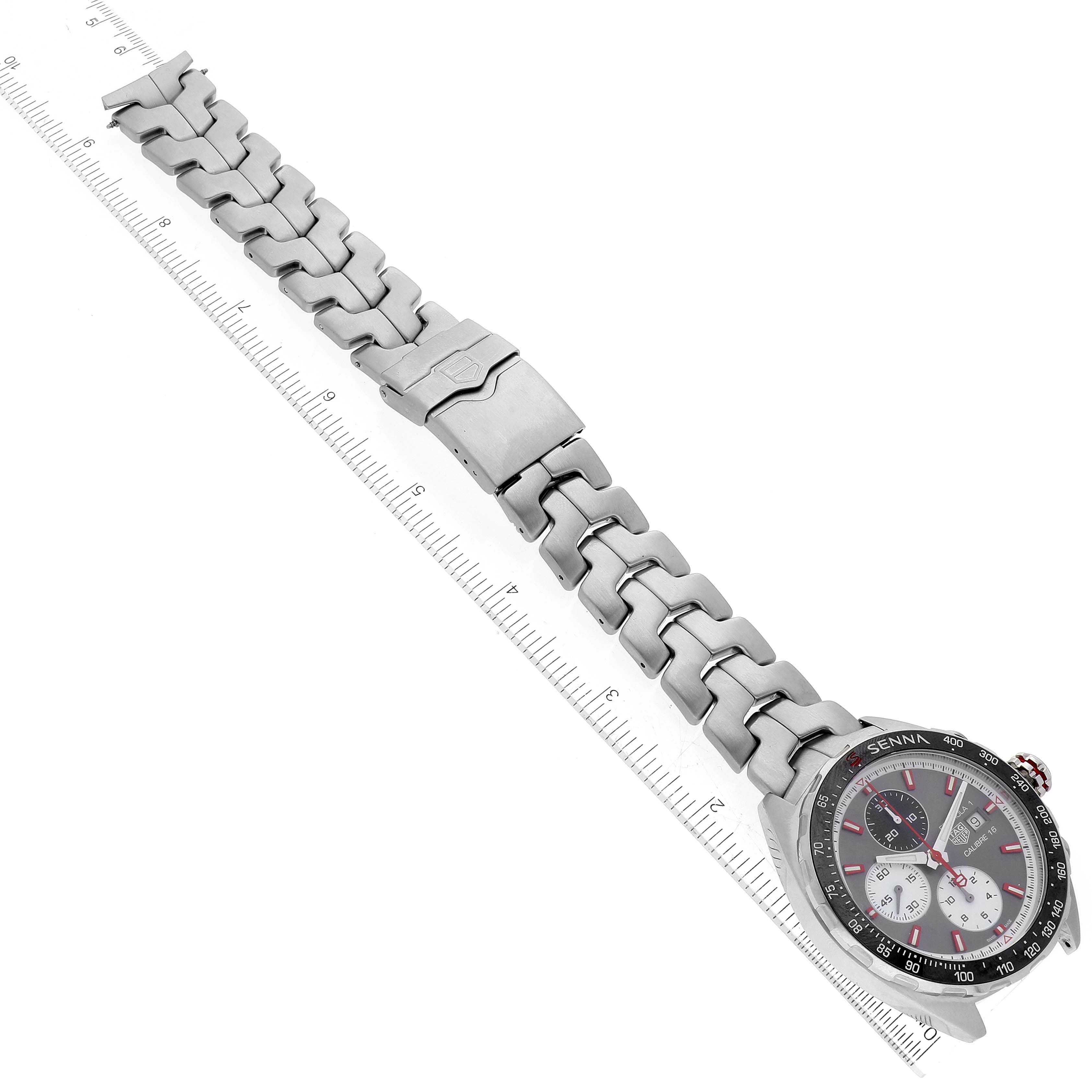 The image shows the face and stainless steel strap of the Tag Heuer Formula 1 CAZ2017.BA0647 Men's Stainless Steel Grey Dial CAZ2017.BA0647 Men's Stainless Steel Grey Dial watch, laid out next to a ruler.