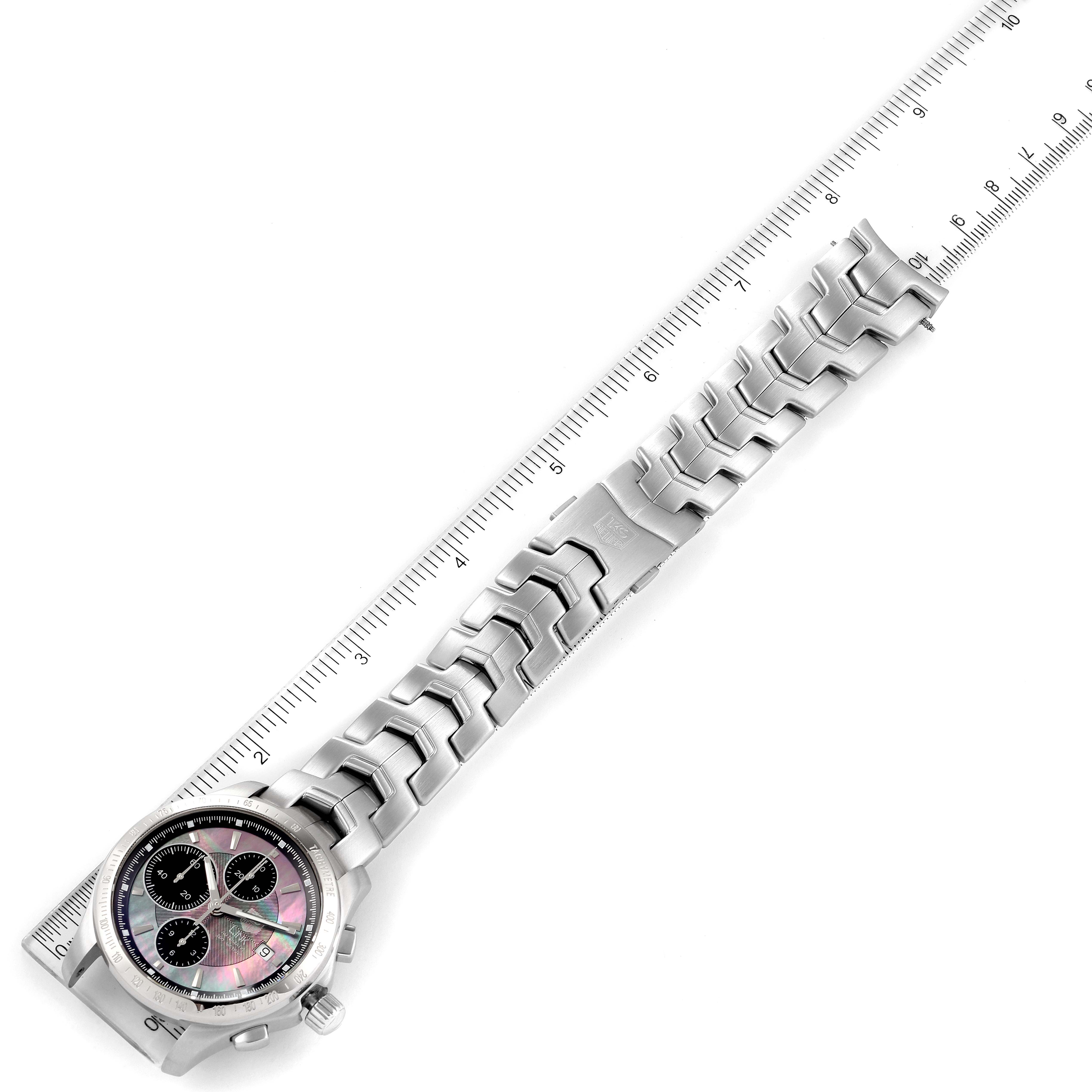 The image shows a Tag Heuer Link model watch from an angled top view, displaying the dial, band, clasp, and a ruler for scale.