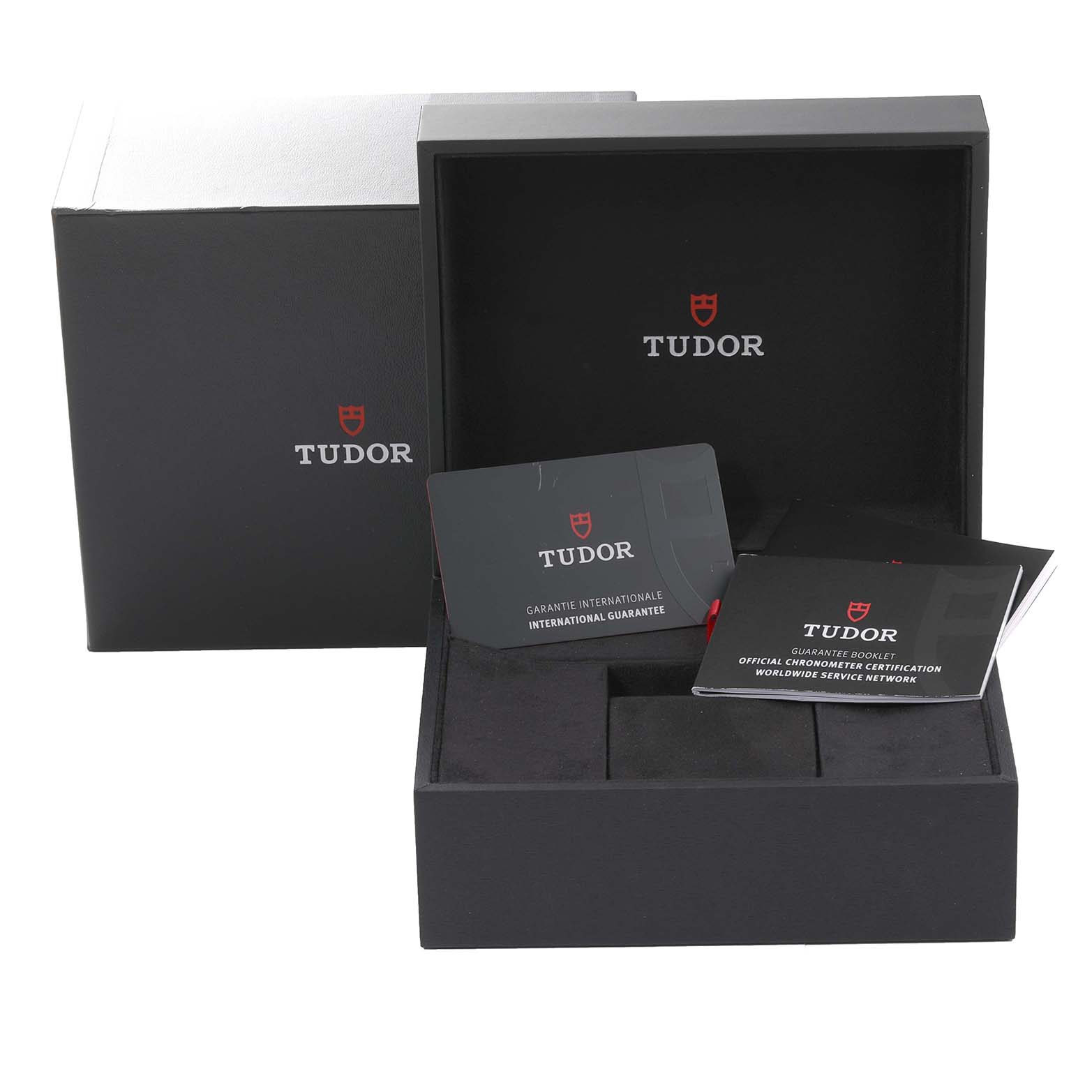 The image shows the packaging, warranty card, and booklet for the Tudor Heritage Black Bay 79733N Men
s Steel and Gold (two tone) Black Dial 79733N Men
s Steel and Gold (two tone) Black Dial watch.
