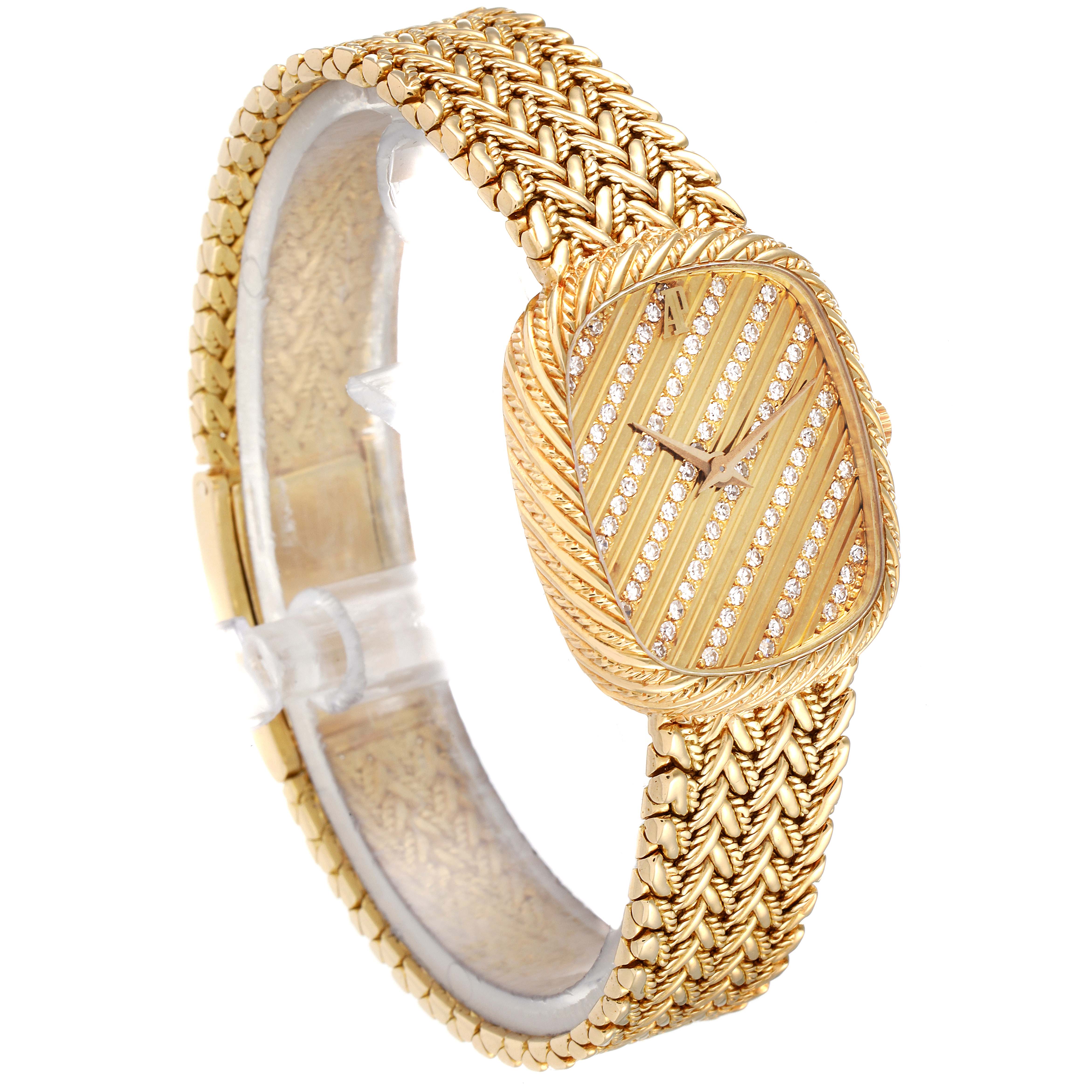 The Audemars Piguet Vintage Women's Yellow Gold Champagne Dial watch is shown at a slight angle, highlighting its woven gold bracelet and striped, diamond-set dial.