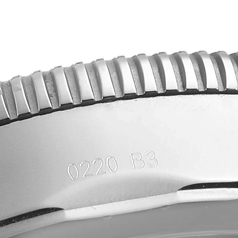 The image shows a close-up of the edge of the bezel of a Breitling Superocean AB016212/G840/154A Men
s Stainless Steel Silver Dial AB016212/G840/154A Men
s Stainless Steel Silver Dial watch.