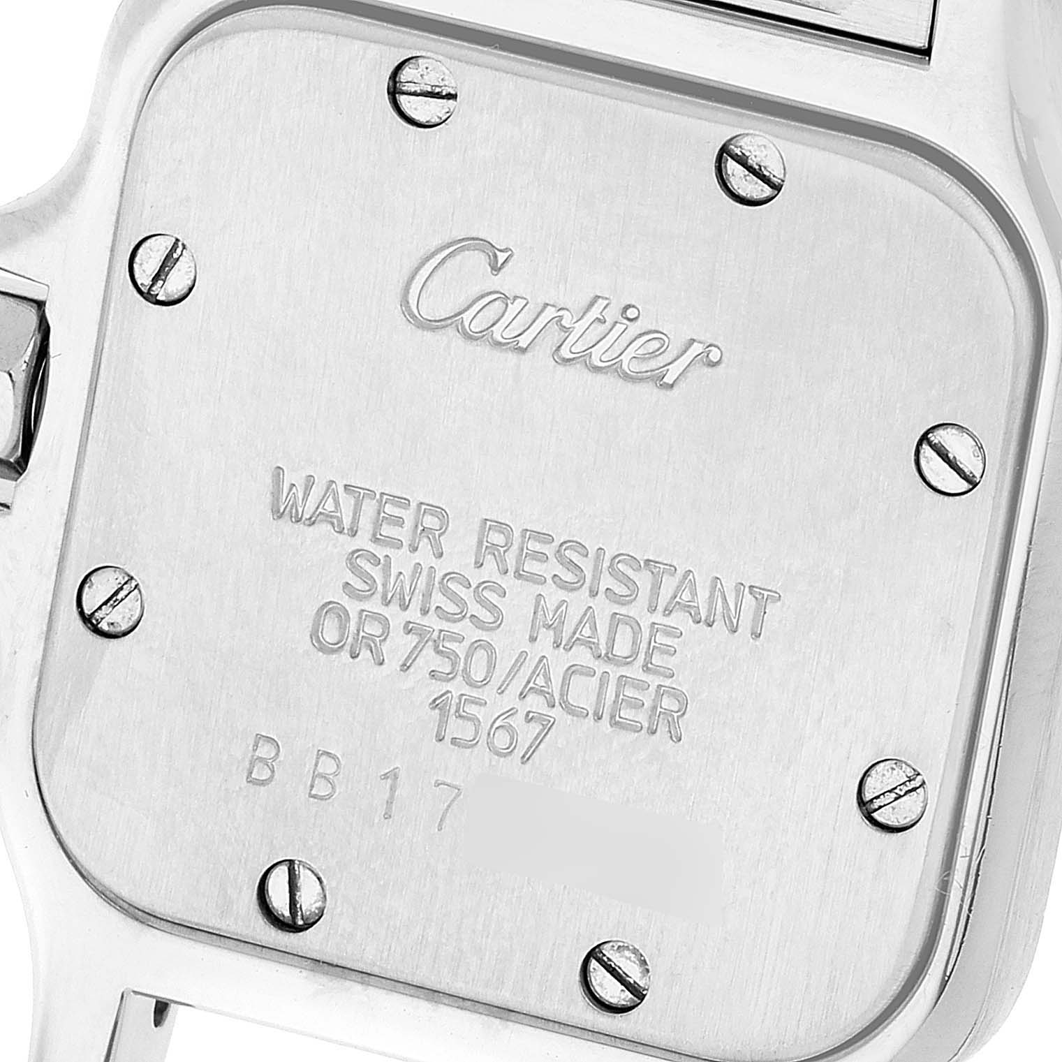 This image shows the back case of a Santos model watch by Cartier, featuring inscriptions and screws.