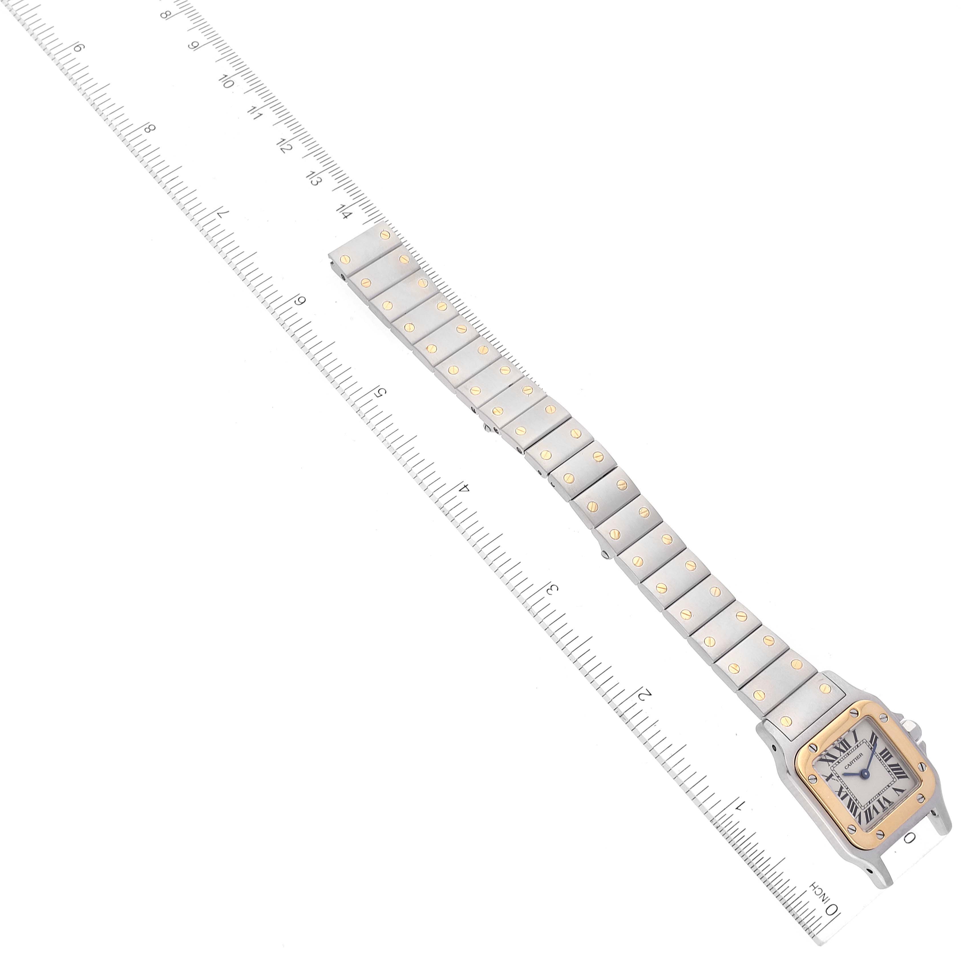 The image shows a top-down view of the Cartier Santos W20012C4 Women's Steel and Gold (two tone) Silver Dial W20012C4 Women's Steel and Gold (two tone) Silver Dial watch, featuring the face and full bracelet laid next to a ruler.
